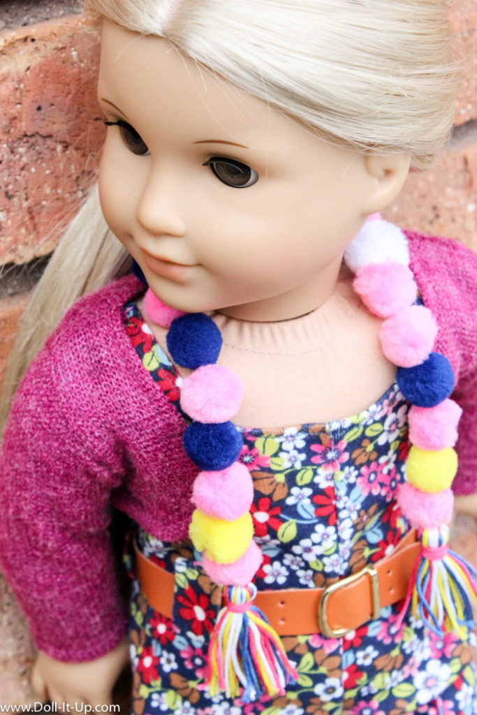Make a pom pom scarf for dolls.